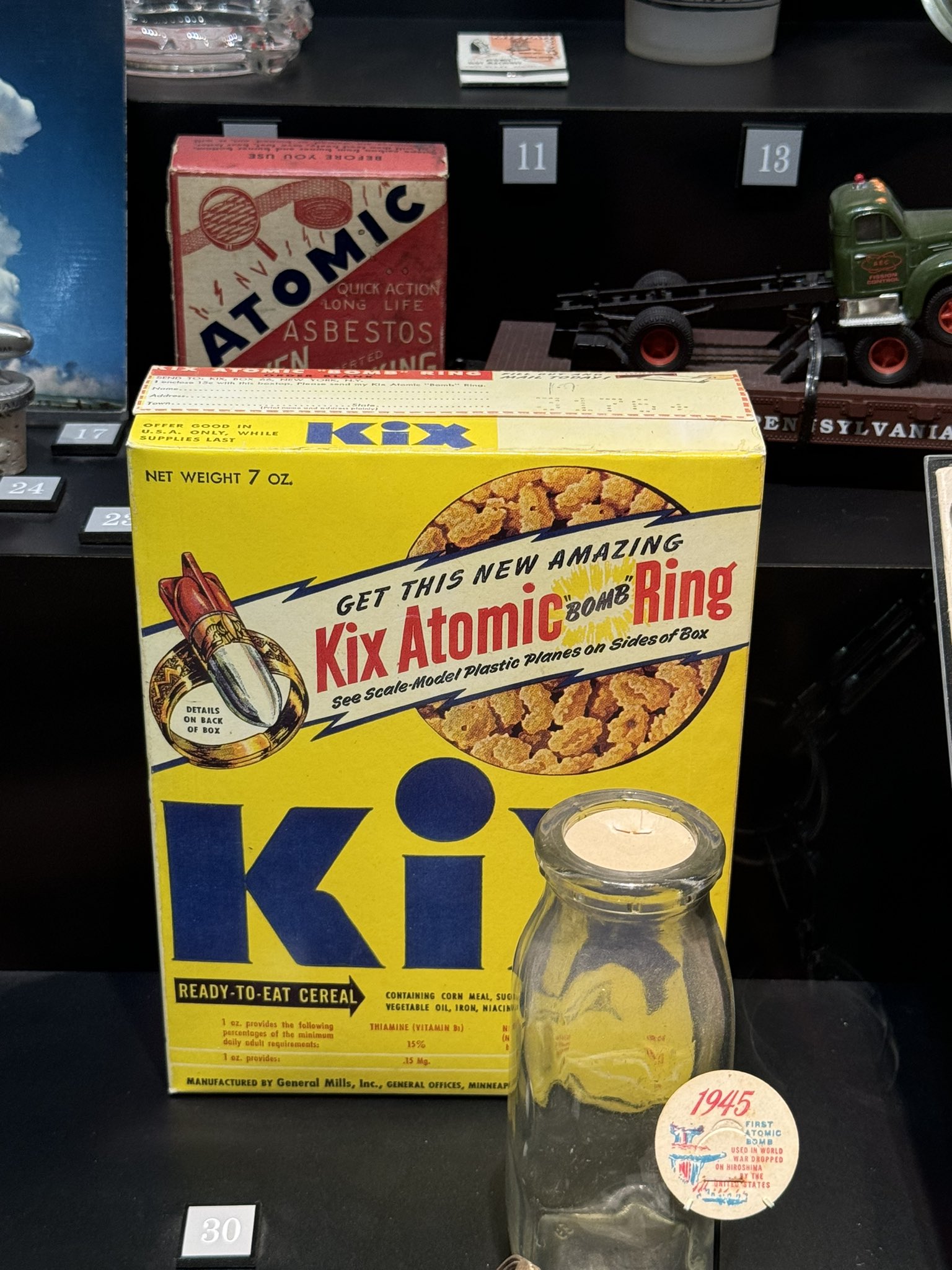 A vintage Kix cereal box displayed behind glass in a museum case