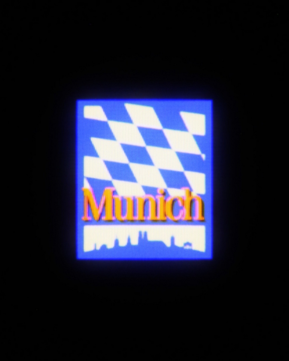 Logo featuring the word 'Munich' with blue and white checkered pattern background.