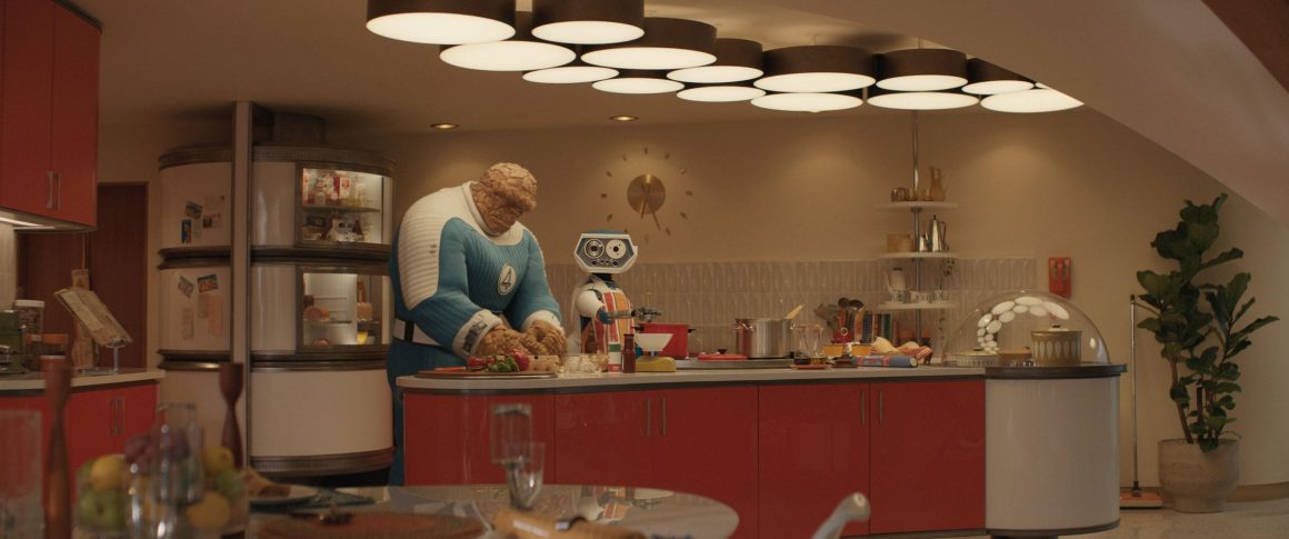 A humanoid character in a blue and white outfit and a robotic companion are preparing food in a modern kitchen with red cabinets and bright overhead lighting.