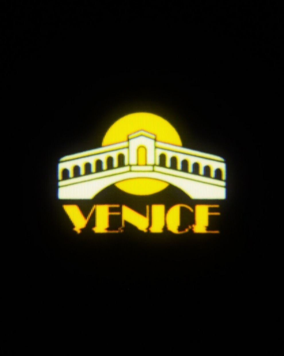 Logo featuring a stylized bridge with a yellow sun in the background and the word 'Venice' in bold letters.