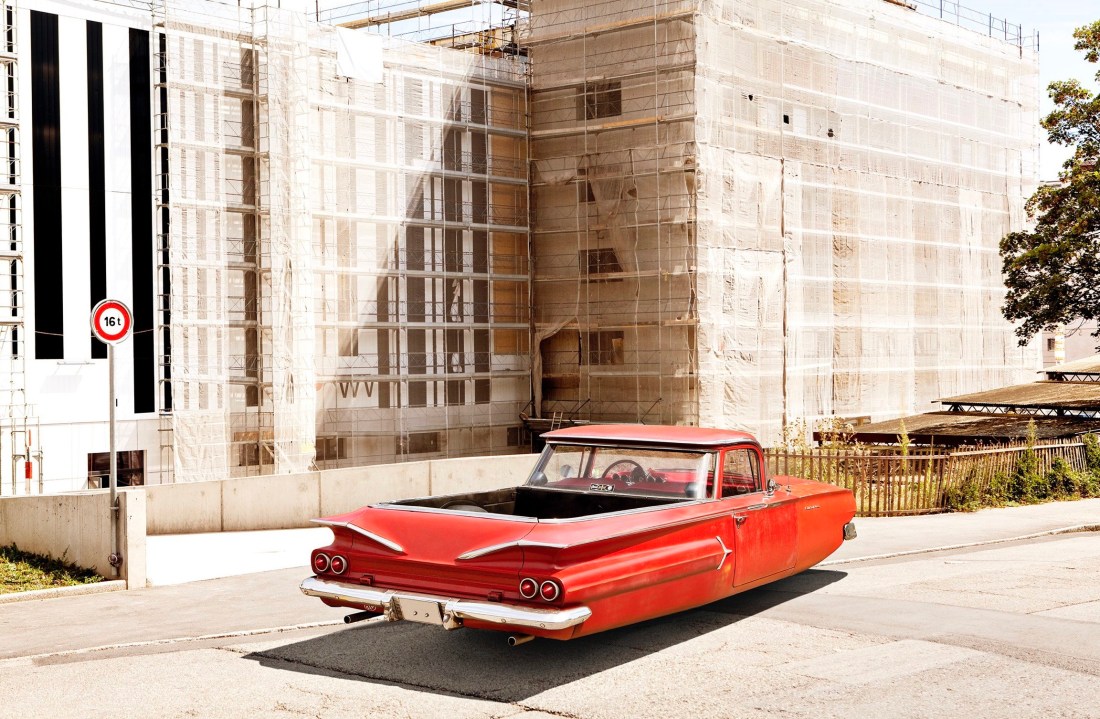 Photograph of a vintage car hovering above the street, by Renaud Marion