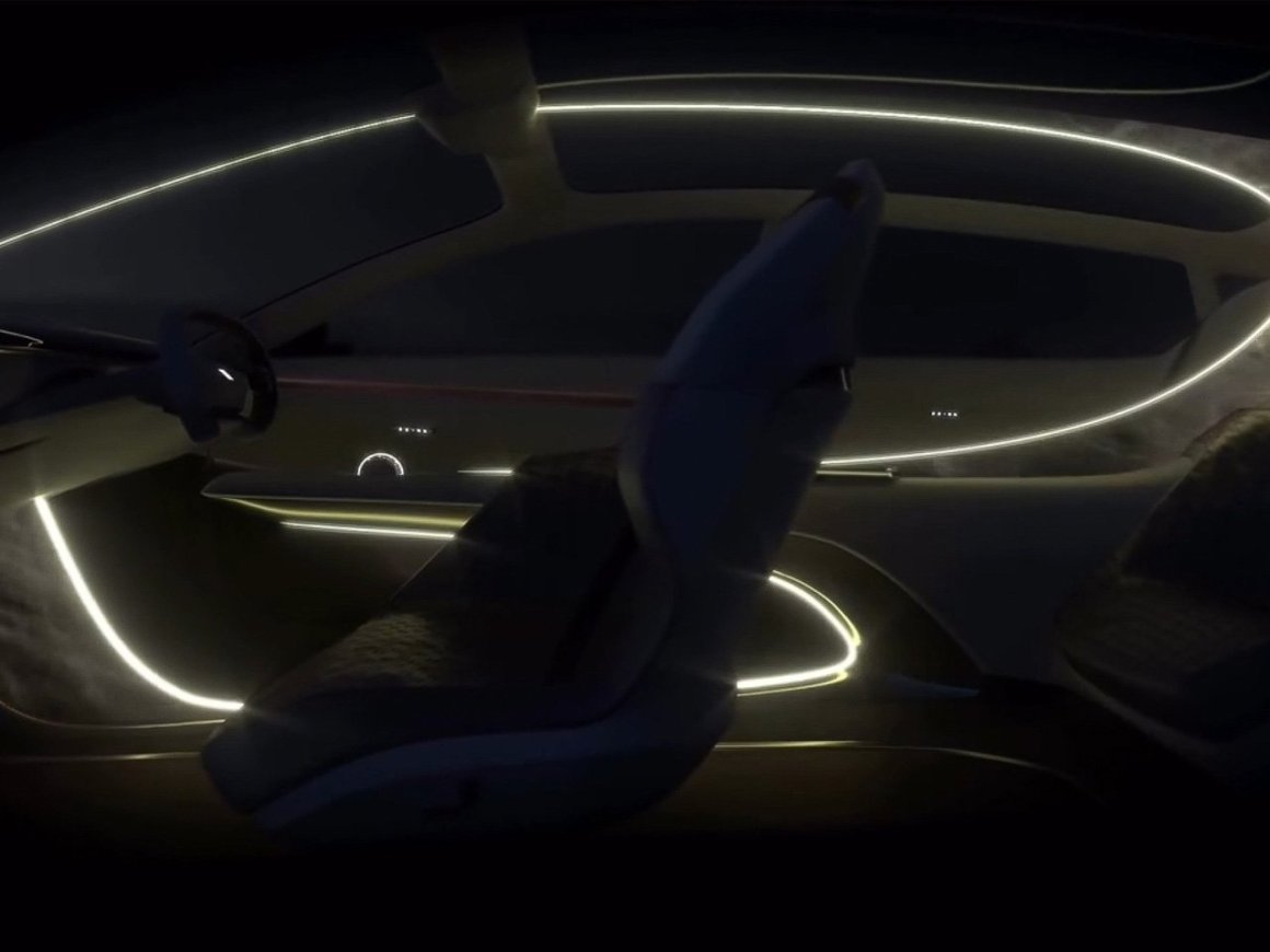 Interior view of the Buick Electra Orbit concept, showcasing a sleek dashboard with ambient lighting and modern seating arrangement.