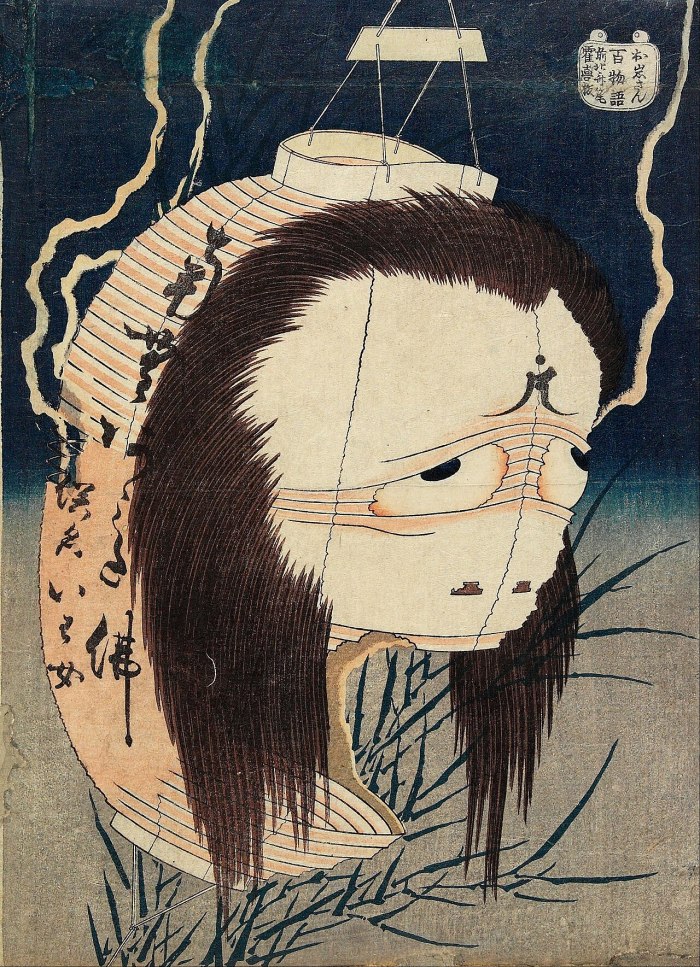 Hokusai woodblock print of the lantern ghost Oiwa, her face formed from a torn paper lantern